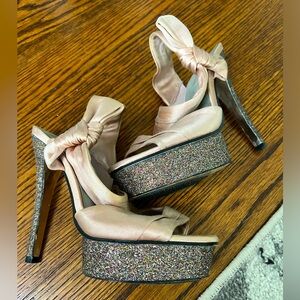Size 6 pink and glittery high heels with bow detailing on side